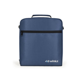 Man carrying O2TOTES Inogen carry bag walking in busy airport departure terminal