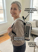 Senior woman wearing portable oxygen concentrator backpack with padded straps, breathable mesh panels, unisex fit.