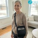 Woman wearing nasal cannula and crossbody oxygen concentrator bag in living room